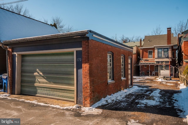 view of snow covered exterior with a garage