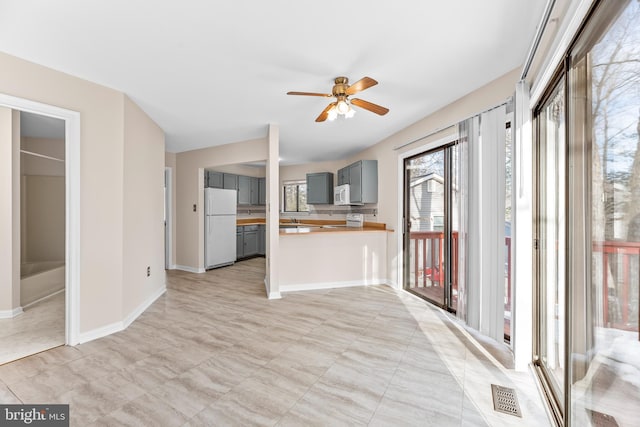 kitchen featuring wood counters, gray cabinetry, white appliances, kitchen peninsula, and ceiling fan