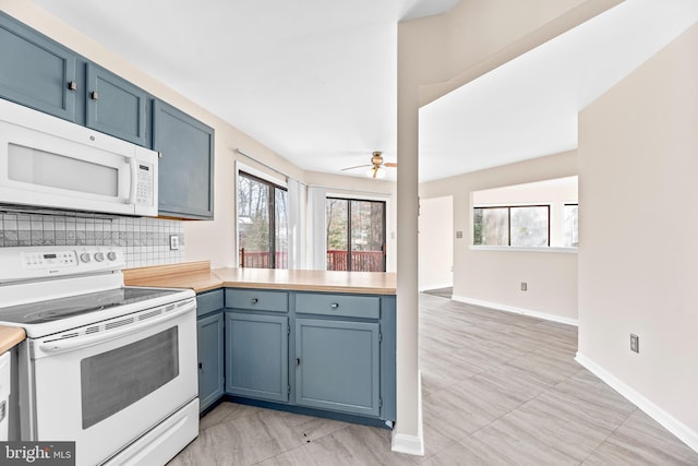 kitchen with white appliances, blue cabinetry, ceiling fan, decorative backsplash, and kitchen peninsula