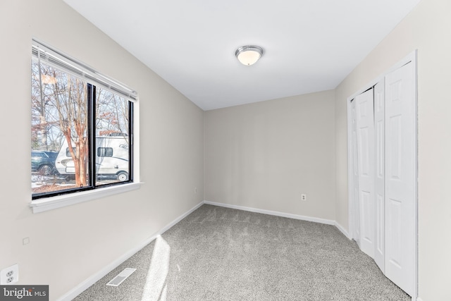 unfurnished bedroom with carpet and a closet