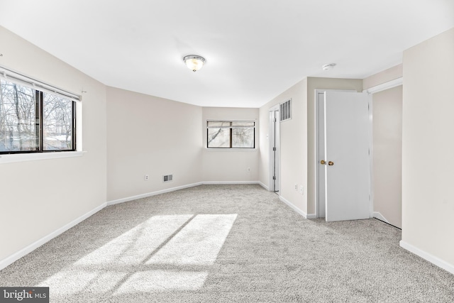 empty room featuring light colored carpet