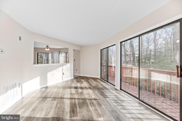 unfurnished room with plenty of natural light and light wood-type flooring