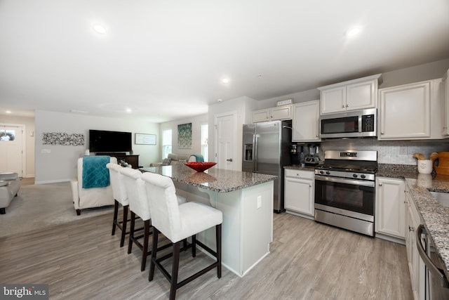 108 Zachary Way, Pottstown, PA 19464 - kitchen with appliances with stainless steel finishes, a kitchen breakfast bar, a kitchen island, open floor plan, and decorative backsplash