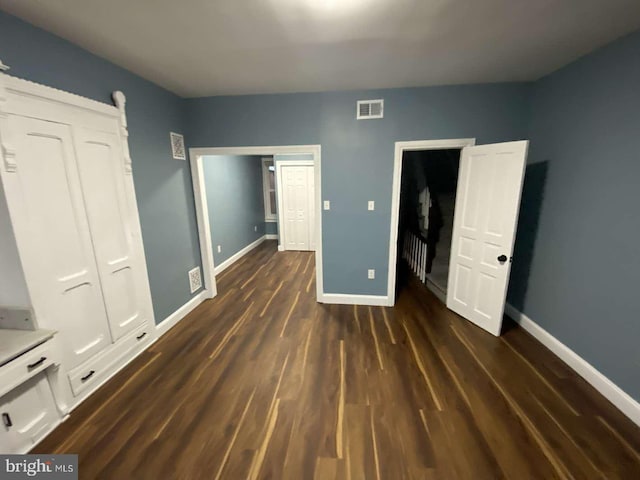 unfurnished bedroom featuring dark hardwood / wood-style flooring