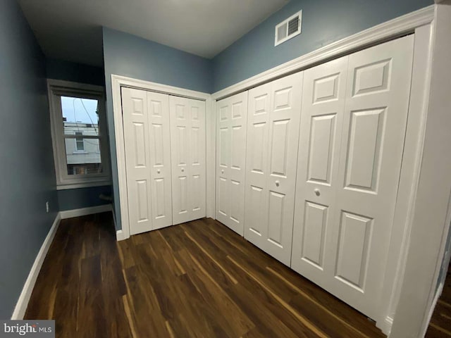 corridor featuring dark hardwood / wood-style floors