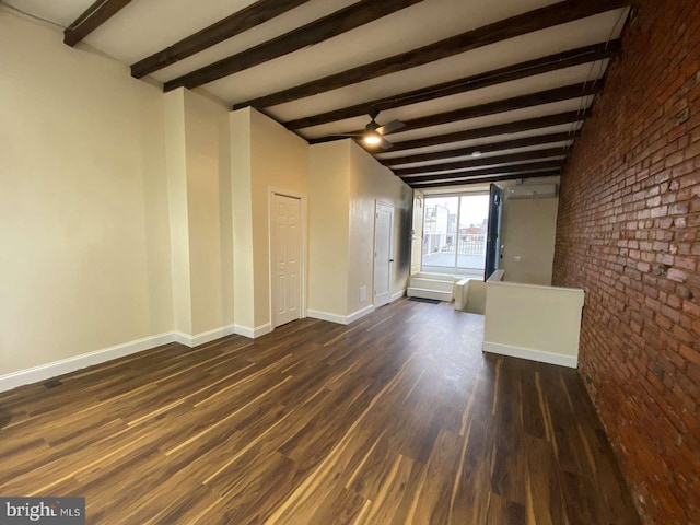 unfurnished living room featuring beam ceiling, brick wall, dark hardwood / wood-style floors, and ceiling fan