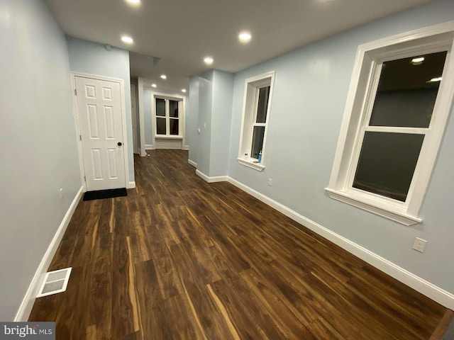 corridor with dark wood-type flooring