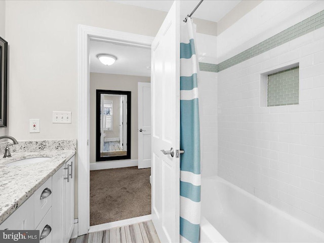 bathroom featuring shower / tub combo, vanity, and hardwood / wood-style floors