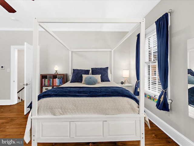 bedroom with dark hardwood / wood-style flooring