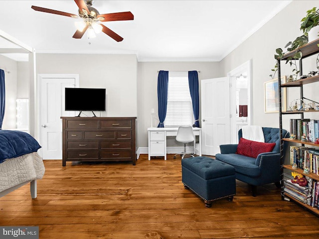 living area with crown molding, ceiling fan, and dark hardwood / wood-style floors