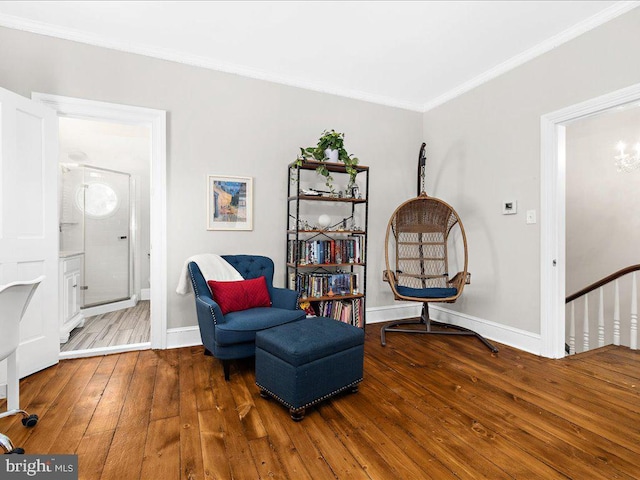 living area featuring hardwood / wood-style flooring and ornamental molding