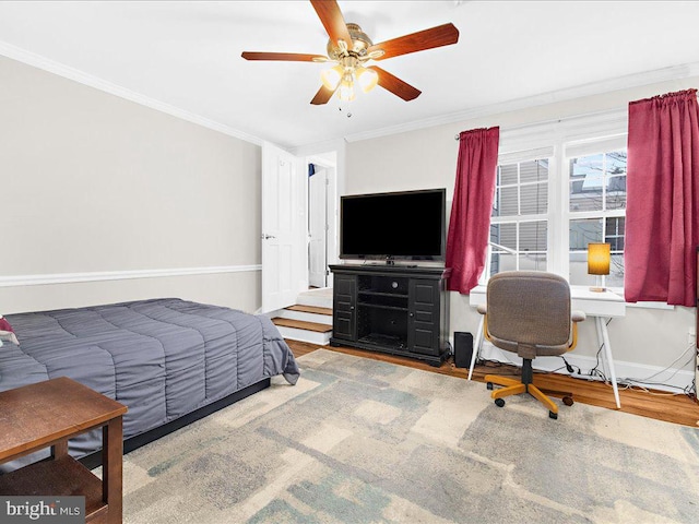 bedroom featuring hardwood / wood-style flooring, ceiling fan, and crown molding