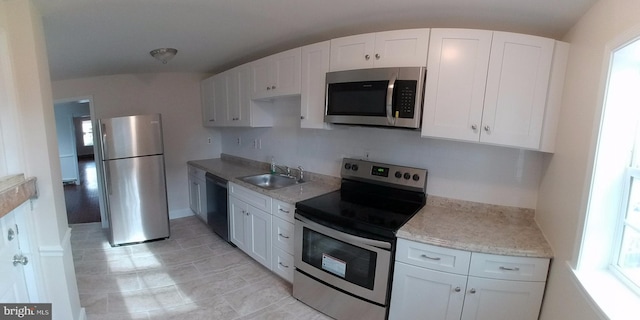 kitchen with white cabinetry, appliances with stainless steel finishes, sink, and plenty of natural light