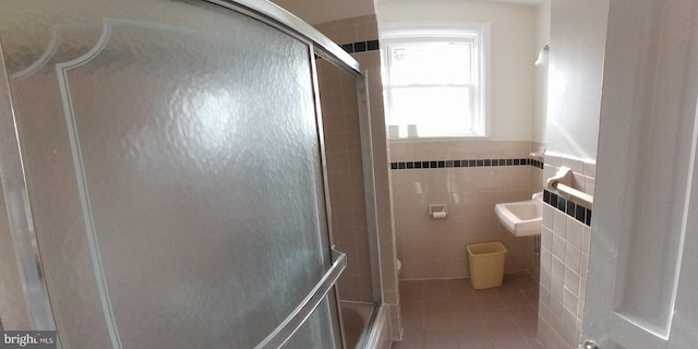 bathroom with tile patterned floors and tile walls