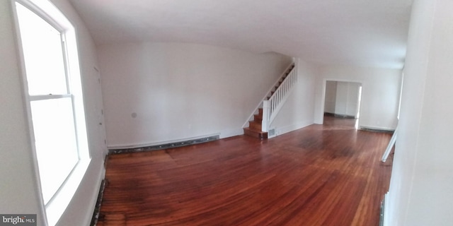 unfurnished room with dark wood-type flooring