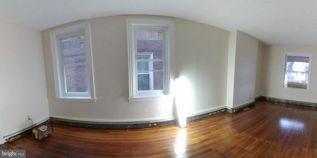 bonus room with dark hardwood / wood-style flooring