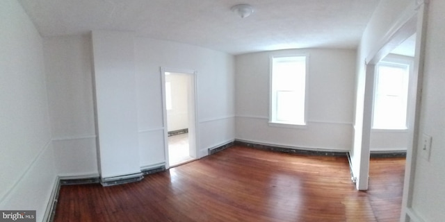 spare room with dark wood-type flooring