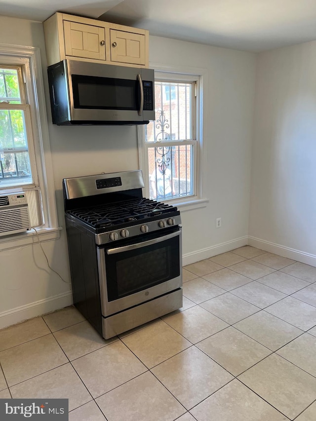 kitchen with cooling unit, light tile patterned floors, and stainless steel appliances