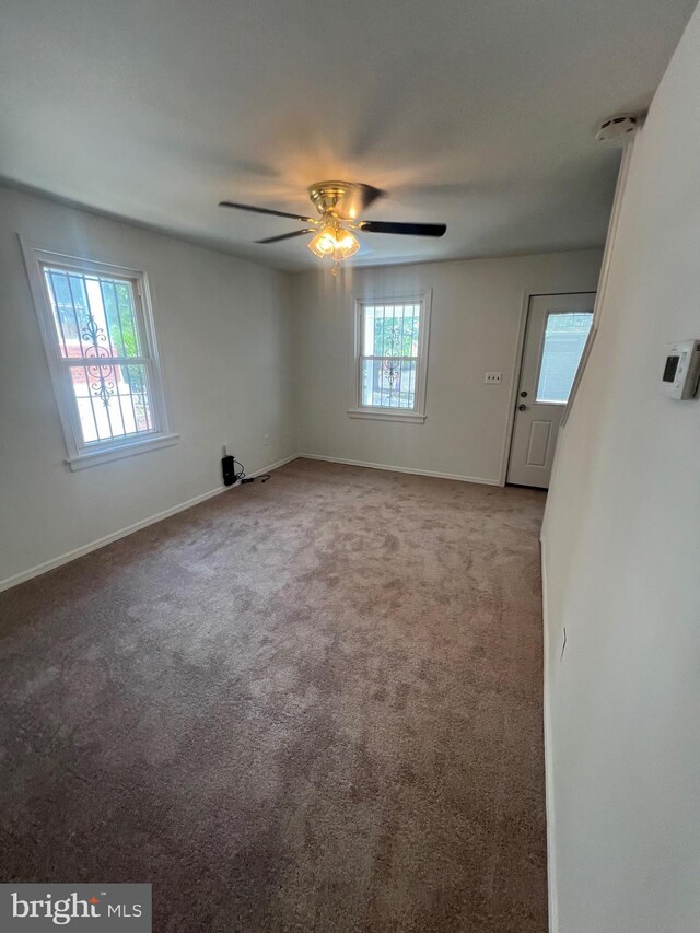 unfurnished room featuring light carpet and ceiling fan