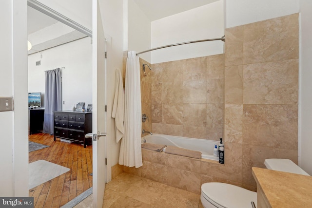 full bathroom featuring vanity, tile walls, toilet, and shower / bath combo with shower curtain