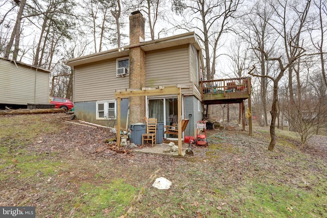 back of house featuring a wooden deck