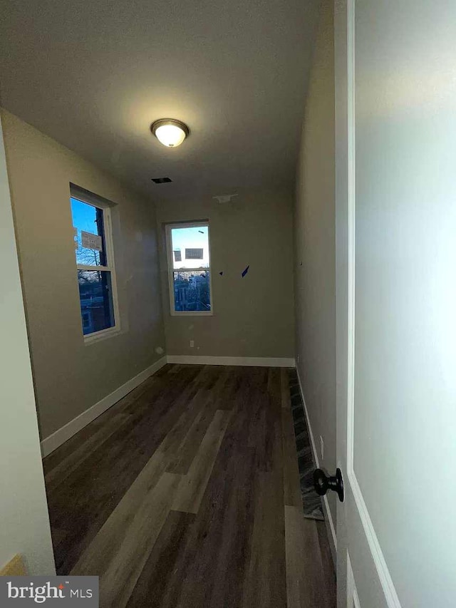 spare room featuring dark wood-type flooring