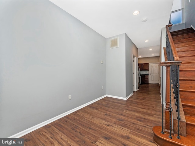 hallway with dark hardwood / wood-style flooring