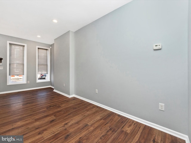 spare room featuring dark wood-type flooring