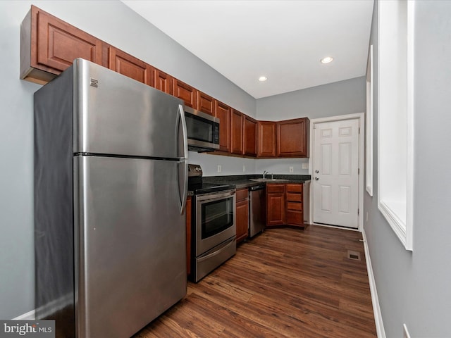 kitchen with stainless steel appliances, sink, and dark hardwood / wood-style flooring