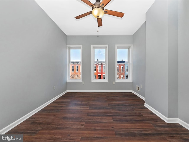 unfurnished room with ceiling fan and dark hardwood / wood-style flooring