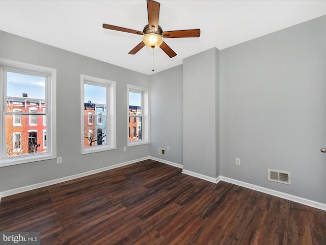 spare room featuring ceiling fan and dark hardwood / wood-style floors