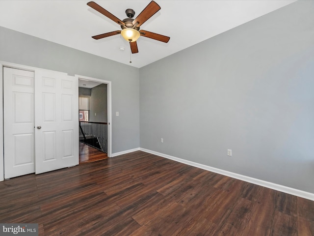 unfurnished bedroom featuring dark hardwood / wood-style flooring, a closet, and ceiling fan