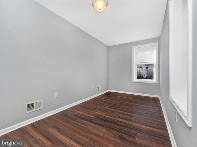 spare room with dark hardwood / wood-style floors