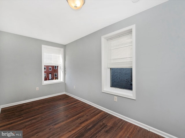 spare room featuring dark hardwood / wood-style flooring