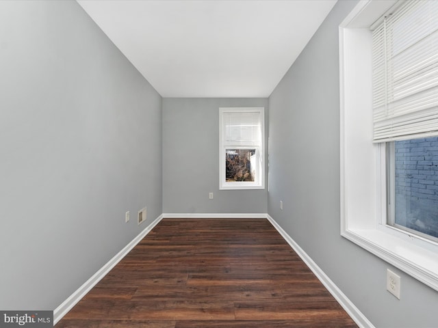 empty room featuring dark hardwood / wood-style flooring