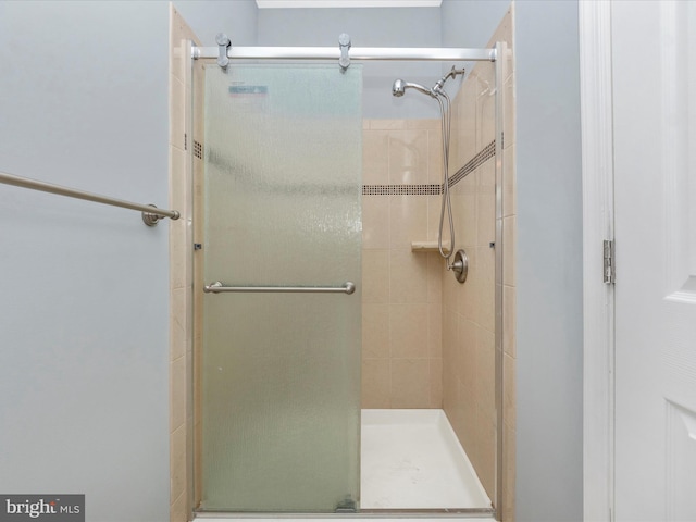 bathroom with a shower with door