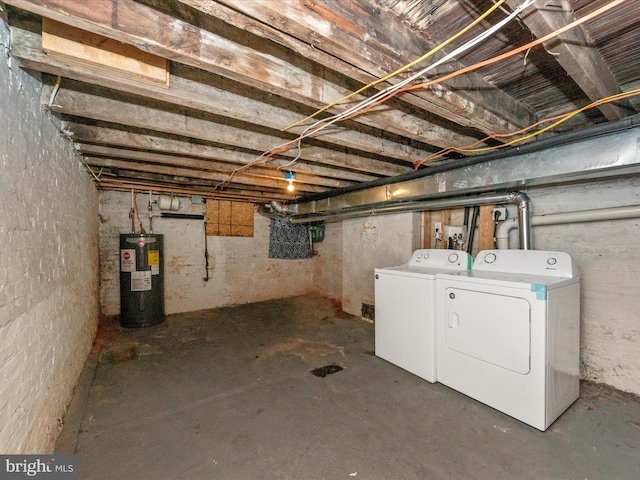 basement featuring washer and clothes dryer and electric water heater