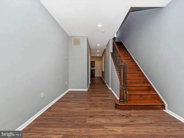 staircase with hardwood / wood-style flooring