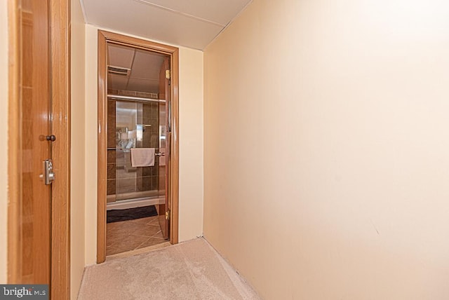 hallway featuring light colored carpet