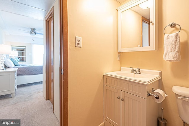 bathroom with vanity, ceiling fan, and toilet