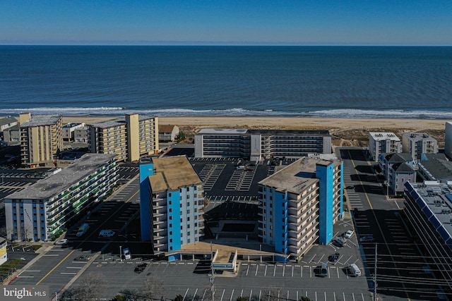 birds eye view of property with a beach view and a water view