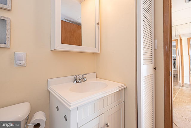 bathroom featuring vanity, toilet, and tile patterned flooring