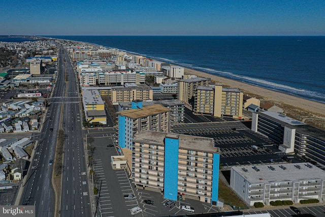 bird's eye view with a water view and a beach view