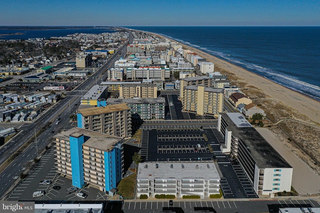 drone / aerial view with a water view and a beach view