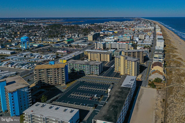 bird's eye view with a water view and a beach view