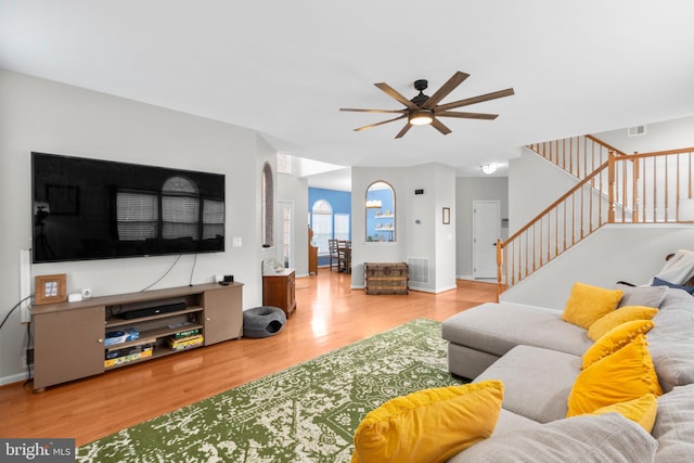 living room with hardwood / wood-style floors and ceiling fan