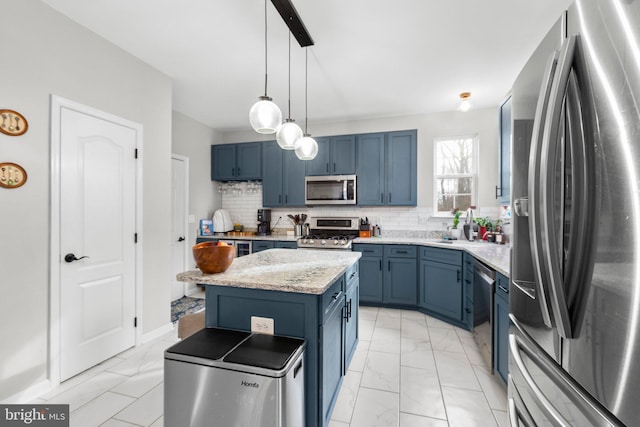 kitchen featuring backsplash, appliances with stainless steel finishes, a center island, and blue cabinets