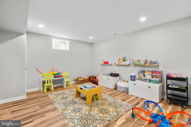 recreation room with hardwood / wood-style floors