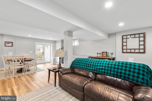 living room featuring french doors and light hardwood / wood-style flooring