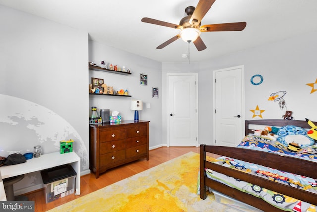 bedroom with ceiling fan and light wood-type flooring